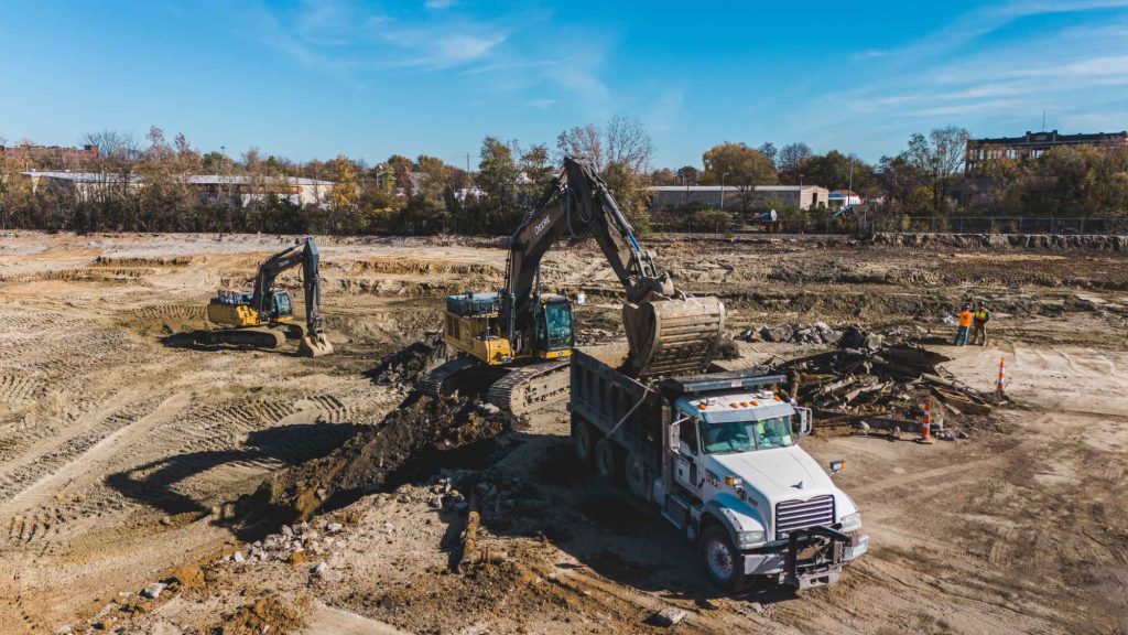 excavator dumping to dump truck